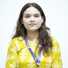 Portrait of a woman with long dark hair, wearing a yellow patterned top and a blue lanyard, facing the camera.