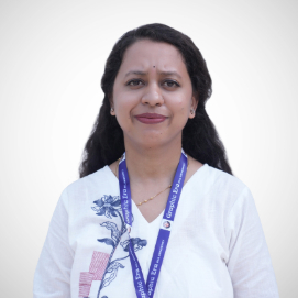 Portrait of a woman with dark hair wearing a white blouse and blue lanyard, facing the camera.