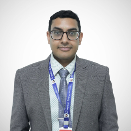 Professional head-and-shoulders portrait of a man in a gray suit, tie, glasses, and a blue lanyard, looking at the camera.