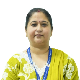 Portrait of an Indian woman facing the camera, wearing a yellow patterned shawl and a blue lanyard with a badge visible.